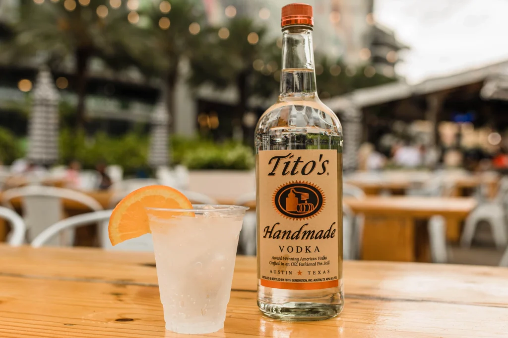 Tito's vodka bottle with vodka cocktail