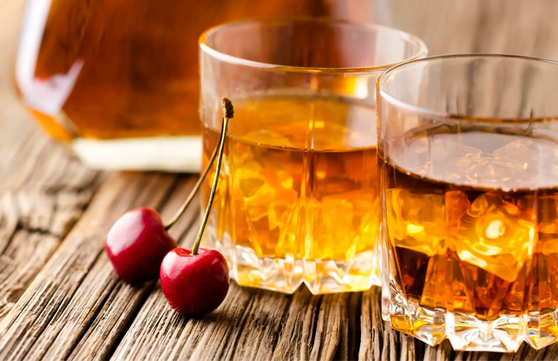 Close up whiskey glasses with ice cherries
