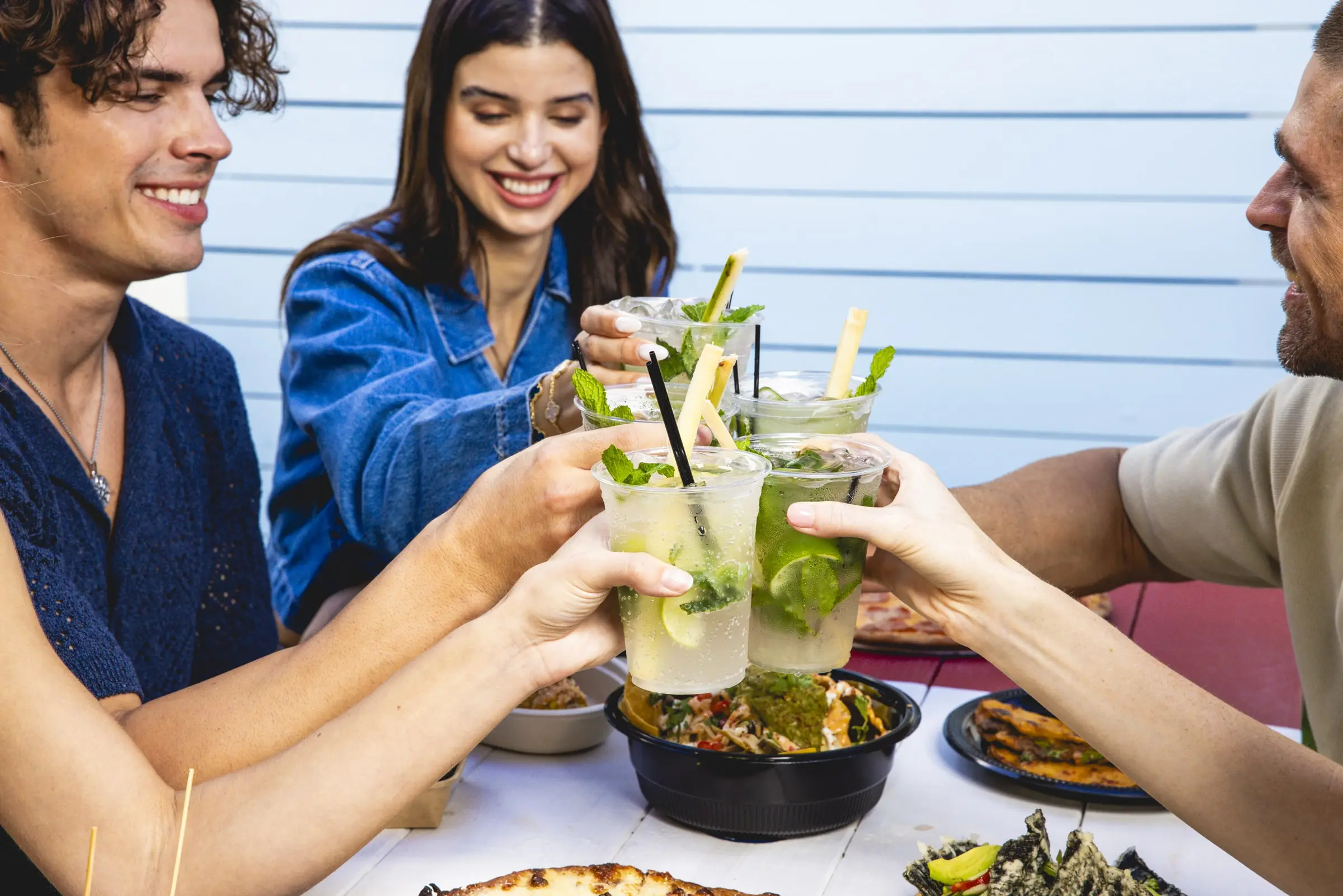 People doing a cheers with Mojitos - The Wharf Fort Lauderdale People doing a cheers with Mojitos